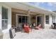 Inviting covered patio with tile flooring, ceiling fan, and outdoor seating area at 307 Ravenshill Way, Deland, FL 32724