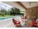A relaxing backyard featuring a pristine pool surrounded by comfortable lounge furniture at 307 Ravenshill Way, Deland, FL 32724