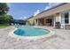Backyard with a kidney-shaped swimming pool, patio area, and lounge chairs perfect for outdoor relaxation at 307 Ravenshill Way, Deland, FL 32724