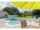 An inviting pool and spa area offers a serene retreat with lush landscaping and comfortable seating at 307 Ravenshill Way, Deland, FL 32724