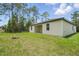 Spacious backyard with lush green grass and mature trees, perfect for outdoor activities at 3121 Canterbury St, Deltona, FL 32738
