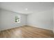 Bright bedroom featuring wood-look flooring, a window, and neutral walls at 3121 Canterbury St, Deltona, FL 32738