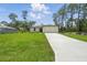 Inviting single-story home with lush green lawn and driveway leading to the two-car garage at 3121 Canterbury St, Deltona, FL 32738