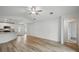 Bright living room showcasing wood floors and access to the kitchen and front entrance at 3121 Canterbury St, Deltona, FL 32738