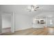 Open living area with wood floors, leading to the kitchen and front door at 3121 Canterbury St, Deltona, FL 32738