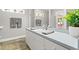 Bathroom with a large counter, simple design, and light blue color scheme at 3132 Mango Tree Dr, Edgewater, FL 32141