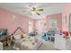 Playful pink bedroom featuring whimsical decor, a comfortable bed, and plenty of space for a to enjoy at 3132 Mango Tree Dr, Edgewater, FL 32141