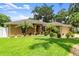Well-manicured home with verdant lawn, fresh landscaping, and a welcoming front facade at 3132 Mango Tree Dr, Edgewater, FL 32141