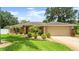 Charming single-story home with a well-manicured lawn and tropical landscaping creating great curb appeal at 3132 Mango Tree Dr, Edgewater, FL 32141