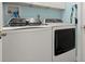Well-equipped laundry room with newer, front-loading washer and dryer units at 3132 Mango Tree Dr, Edgewater, FL 32141