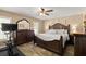 Comfortable main bedroom with a dark wood furniture set, ceiling fan, and natural light from the window at 3132 Mango Tree Dr, Edgewater, FL 32141