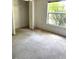 A plain bedroom with a closet, window and carpeted floor in need of cleaning at 3155 Mapleshade St, Deltona, FL 32738