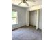 Bedroom featuring carpeted floors and a spacious closet at 3155 Mapleshade St, Deltona, FL 32738