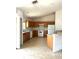 Functional kitchen with wood cabinets, tile floor, and white appliances at 3155 Mapleshade St, Deltona, FL 32738