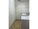 Utility room with tile flooring, showing the door to the outside and washing machine at 3155 Mapleshade St, Deltona, FL 32738