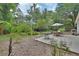 Large backyard featuring a patio seating area surrounded by beautiful trees and plants at 319 N Salisbury Ave, Deland, FL 32720