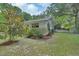 Spacious backyard with mature trees, lush lawn, and white exterior of the house at 319 N Salisbury Ave, Deland, FL 32720