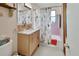 Charming bathroom featuring floral shower curtain, vanity storage, and pink tiling at 319 N Salisbury Ave, Deland, FL 32720