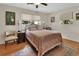 Charming bedroom with hardwood floors, a ceiling fan, neutral walls and multiple windows for natural light at 319 N Salisbury Ave, Deland, FL 32720