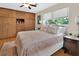 Bedroom featuring a large closet, hardwood floors, a ceiling fan, and multiple windows for natural light at 319 N Salisbury Ave, Deland, FL 32720