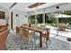 Bright dining area with large windows, modern light fixture and hardwood table at 319 N Salisbury Ave, Deland, FL 32720