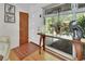 Bright entryway with a wooden console table, large windows, and unique artwork at 319 N Salisbury Ave, Deland, FL 32720