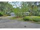 Attractive home exterior with mature trees, lush lawn, and circular driveway at 319 N Salisbury Ave, Deland, FL 32720