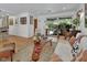 Bright living room featuring stylish mid-century modern furniture, large windows and hardwood floors at 319 N Salisbury Ave, Deland, FL 32720