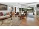 Inviting living room featuring stylish mid-century modern furniture and sliding doors to the patio at 319 N Salisbury Ave, Deland, FL 32720