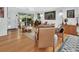 Cozy living room featuring hardwood floors, large windows, and brick accent wall at 319 N Salisbury Ave, Deland, FL 32720