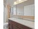 Cozy bathroom with dark wood vanity, bright countertop, and framed mirror at 33 Coquina Ridge Way, Ormond Beach, FL 32174