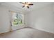 Cozy bedroom with natural light, neutral walls, carpeted floors, and a large window with drapes at 33 Coquina Ridge Way, Ormond Beach, FL 32174