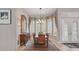 Formal dining room featuring a large window, chandelier, and stylish wooden furniture at 33 Coquina Ridge Way, Ormond Beach, FL 32174