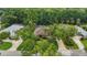 A home with a tile roof surrounded by mature trees and lush landscaping at 33 Coquina Ridge Way, Ormond Beach, FL 32174