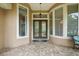 Charming covered front porch with double glass doors and sidelight windows at 33 Coquina Ridge Way, Ormond Beach, FL 32174