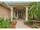Inviting entryway with brick pavers, decorative plants, and a double door entrance at 33 Coquina Ridge Way, Ormond Beach, FL 32174