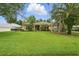 Attractive single-story home with a well-kept lawn and mature trees, providing shade and character at 33 Coquina Ridge Way, Ormond Beach, FL 32174
