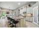 Spacious kitchen featuring a central island, white cabinetry, granite counters, and seamless flow into the living area at 33 Coquina Ridge Way, Ormond Beach, FL 32174