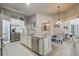 Kitchen view highlighting the central island, granite countertops, stainless steel appliances, and adjacent dining area at 33 Coquina Ridge Way, Ormond Beach, FL 32174