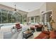 Covered patio with comfortable seating, a ceiling fan, and a view of the pool and backyard at 33 Coquina Ridge Way, Ormond Beach, FL 32174