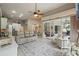 Expansive living area with tile floors, white furniture, and sliding glass doors to outdoor area at 33 Coquina Ridge Way, Ormond Beach, FL 32174