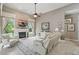 Cozy living room with a fireplace, TV, and comfortable seating, bathed in natural light at 33 Coquina Ridge Way, Ormond Beach, FL 32174