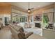 Open living area with a fireplace, TV, and views of the pool through sliding glass doors at 33 Coquina Ridge Way, Ormond Beach, FL 32174
