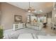 Open-concept living space with white furnishings, tile flooring, and views into the kitchen at 33 Coquina Ridge Way, Ormond Beach, FL 32174