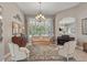 Sun-filled living room with large windows overlooking the pool, elegant furniture and tile flooring at 33 Coquina Ridge Way, Ormond Beach, FL 32174