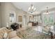 Bright living room featuring tile floors, archways, and views into the dining room and kitchen at 33 Coquina Ridge Way, Ormond Beach, FL 32174