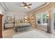 Spacious main bedroom features tray ceilings, a ceiling fan, a large window, and a sitting area at 33 Coquina Ridge Way, Ormond Beach, FL 32174