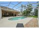 An outdoor pool with a screened enclosure and brick pavers at 33 Coquina Ridge Way, Ormond Beach, FL 32174