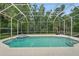 A screened pool and spa with lush, tropical landscaping at 33 Coquina Ridge Way, Ormond Beach, FL 32174