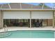 Screened in pool with covered patio and backyard grill at 33 Coquina Ridge Way, Ormond Beach, FL 32174